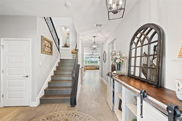 4108 Mellon Dr, Odessa, FL 33556 - foyer featuring light wood-type flooring, visible vents, a chandelier, stairs, and baseboards