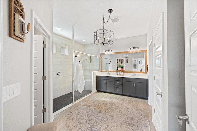 4108 Mellon Dr, Odessa, FL 33556 - full bathroom featuring a shower stall, visible vents, double vanity, and wood finished floors