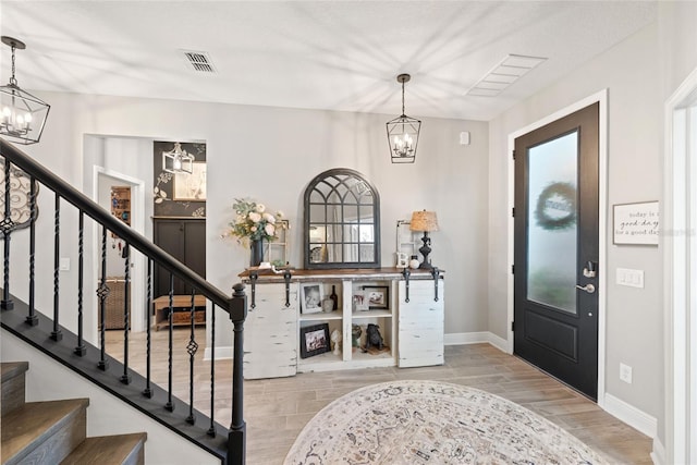 4108 Mellon Dr, Odessa, FL 33556 - entryway with wood finished floors, an inviting chandelier, baseboards, and stairway