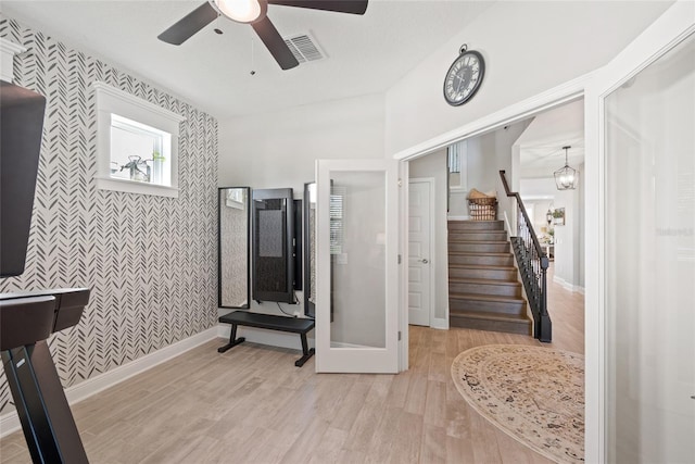 4108 Mellon Dr, Odessa, FL 33556 - interior space featuring baseboards, stairway, visible vents, ceiling fan with notable chandelier, and wood finished floors