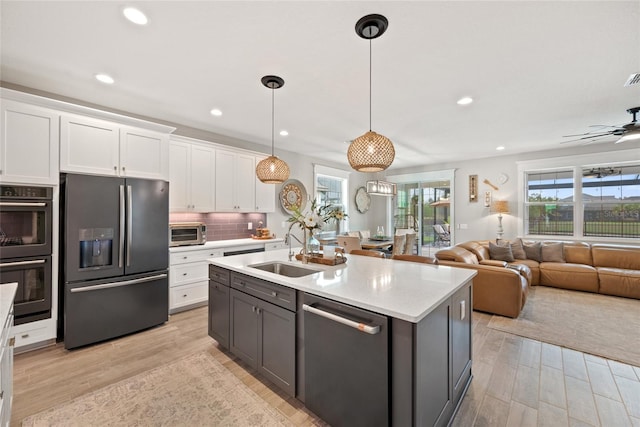 4108 Mellon Dr, Odessa, FL 33556 - kitchen featuring a sink, light countertops, light wood-type flooring, white cabinetry, and stainless steel appliances
