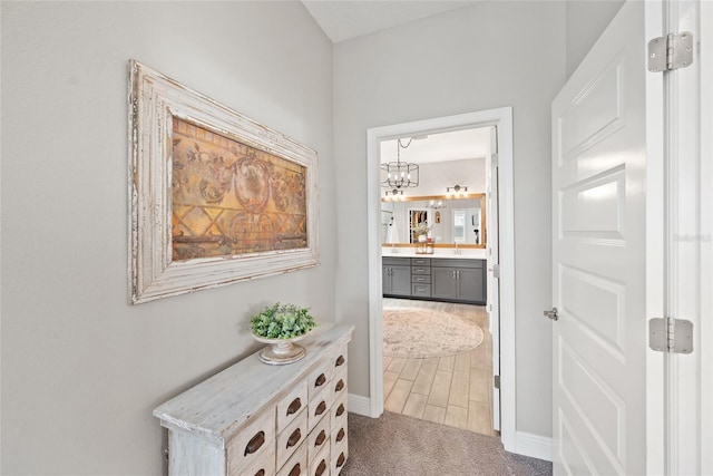 4108 Mellon Dr, Odessa, FL 33556 - hall with carpet, baseboards, and an inviting chandelier