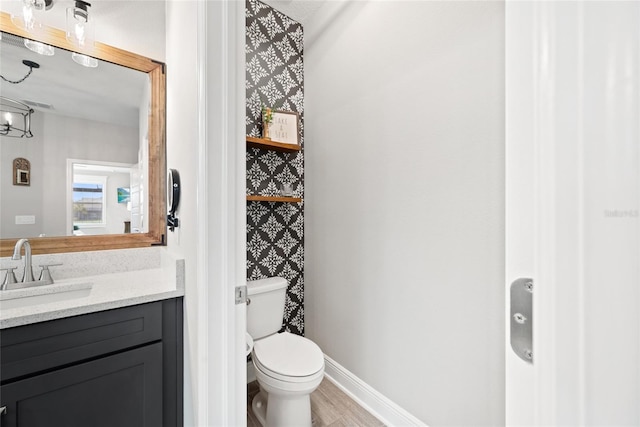 4108 Mellon Dr, Odessa, FL 33556 - bathroom with vanity, baseboards, toilet, and wood finished floors