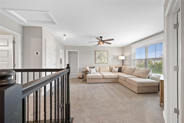 4108 Mellon Dr, Odessa, FL 33556 - living room featuring a textured ceiling, a ceiling fan, attic access, carpet flooring, and baseboards