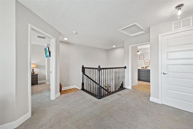 4108 Mellon Dr, Odessa, FL 33556 - corridor featuring visible vents, baseboards, an upstairs landing, carpet floors, and attic access