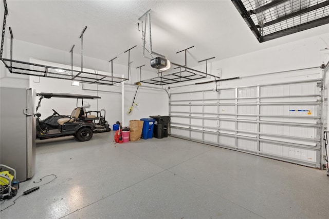 4108 Mellon Dr, Odessa, FL 33556 - garage featuring freestanding refrigerator and a garage door opener