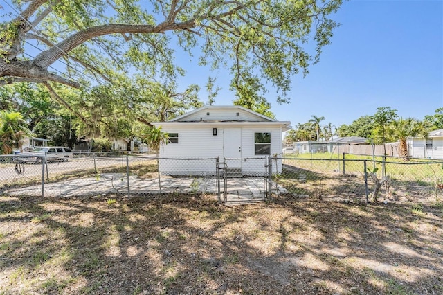 rear view of house with fence private yard and a gate