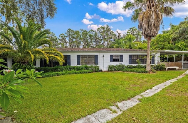 22129 Carson Dr, Land O Lakes, FL 34639 - view of front of home with an attached carport and a front lawn