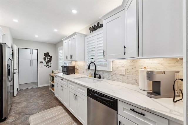 506 Spring Tree Ct, Tarpon Springs, FL 34689 - kitchen with appliances with stainless steel finishes, a sink, decorative backsplash, white cabinetry, and recessed lighting
