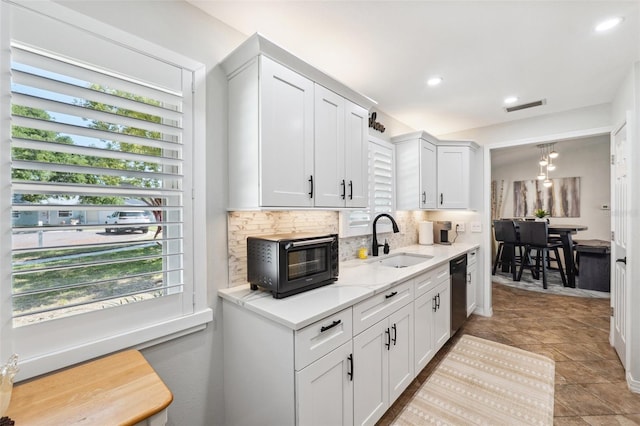 506 Spring Tree Ct, Tarpon Springs, FL 34689 - kitchen with a sink, dishwasher, plenty of natural light, decorative backsplash, and recessed lighting