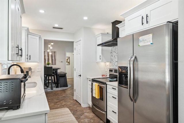 506 Spring Tree Ct, Tarpon Springs, FL 34689 - kitchen featuring appliances with stainless steel finishes, wall chimney exhaust hood, white cabinetry, recessed lighting, and baseboards