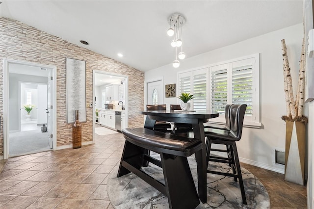 506 Spring Tree Ct, Tarpon Springs, FL 34689 - dining space featuring lofted ceiling and baseboards