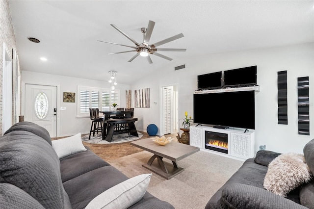 506 Spring Tree Ct, Tarpon Springs, FL 34689 - living room featuring ceiling fan, a glass covered fireplace, vaulted ceiling, and baseboards