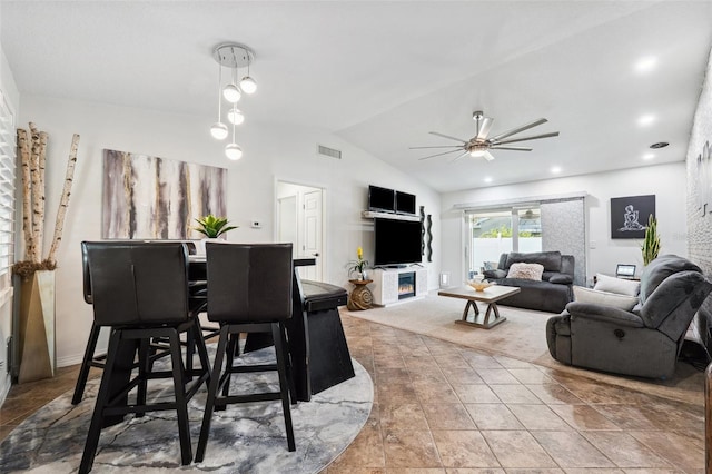 506 Spring Tree Ct, Tarpon Springs, FL 34689 - dining area with ceiling fan, lofted ceiling, and a glass covered fireplace