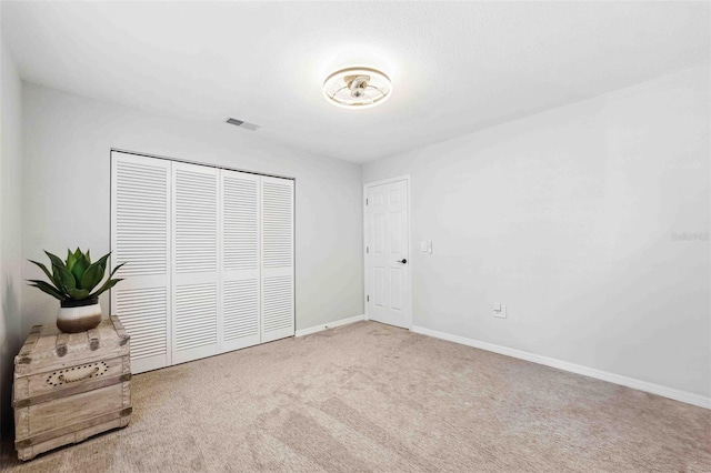 506 Spring Tree Ct, Tarpon Springs, FL 34689 - unfurnished bedroom featuring carpet, a closet, and baseboards