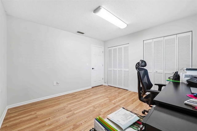 506 Spring Tree Ct, Tarpon Springs, FL 34689 - home office featuring wood finished floors, a textured ceiling, and baseboards