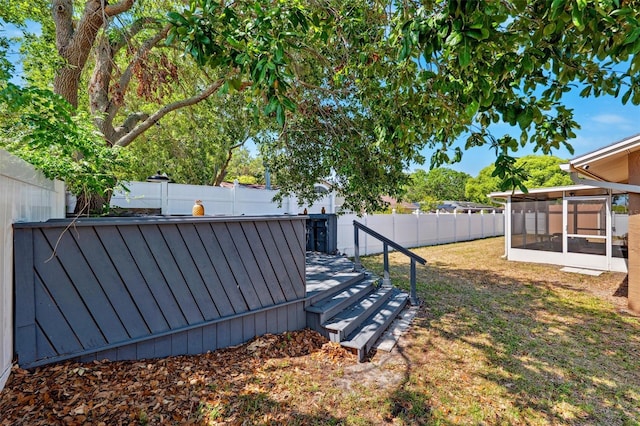 506 Spring Tree Ct, Tarpon Springs, FL 34689 - fenced backyard with a sunroom
