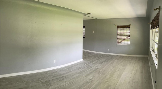4301 15th Ave N, Saint Petersburg, FL 33713 - spare room with baseboards, wood finished floors, and visible vents