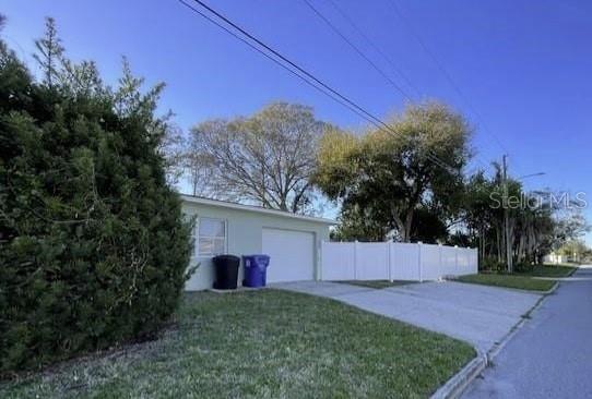 4301 15th Ave N, Saint Petersburg, FL 33713 - exterior space with fence, an attached garage, a yard, and driveway
