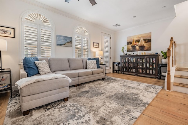 409 Regent Ln N, Saint Petersburg, FL 33701 - living room with ornamental molding, stairs, visible vents, ceiling fan, and wood finished floors