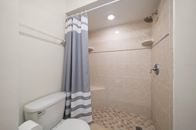 bathroom featuring toilet, a shower stall, and recessed lighting