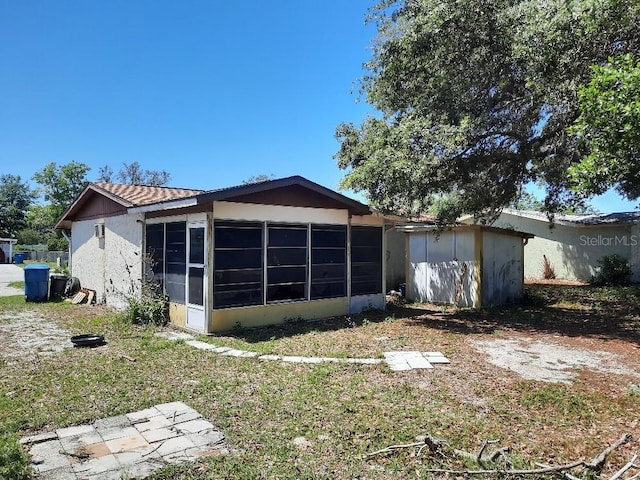 9355 Pinero St, Spring Hill, FL 34608 - view of home's exterior featuring a sunroom and stucco siding