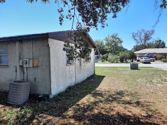 9355 Pinero St, Spring Hill, FL 34608 - view of home's exterior featuring stucco siding and central AC