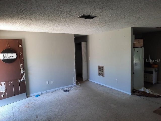 9355 Pinero St, Spring Hill, FL 34608 - unfurnished room featuring visible vents, carpet flooring, and a textured ceiling