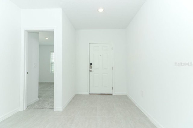 spare room with light tile patterned floors, baseboards, and recessed lighting