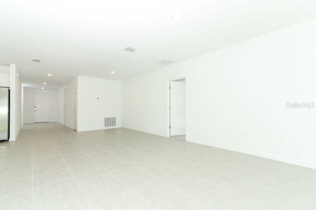 spare room featuring visible vents, baseboards, and recessed lighting