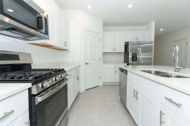 kitchen with light countertops, recessed lighting, a sink, and stainless steel appliances