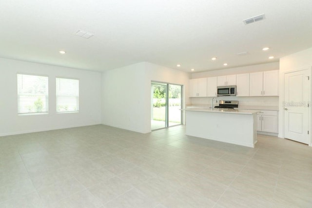 kitchen featuring white cabinets, recessed lighting, light countertops, and appliances with stainless steel finishes