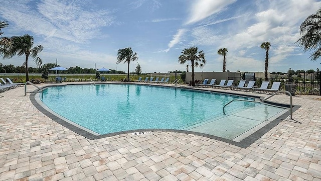 pool featuring a patio area and fence