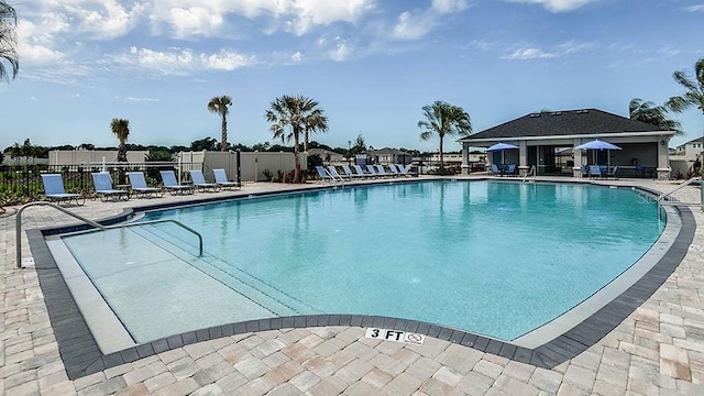 pool featuring a patio area and fence