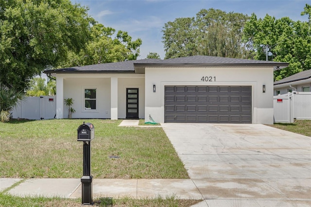 view of front of property with stucco siding, fence, a front lawn, concrete driveway, and an attached garage