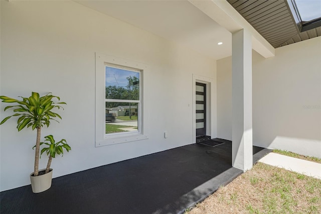 view of exterior entry featuring stucco siding
