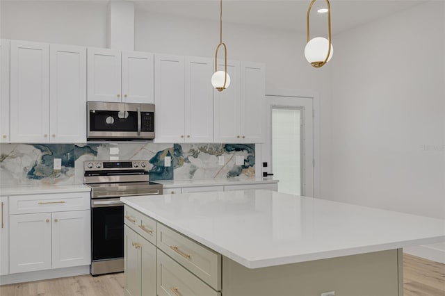 kitchen with light wood-style floors, stainless steel appliances, decorative backsplash, and light countertops