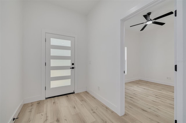 foyer with light wood finished floors, ceiling fan, and baseboards