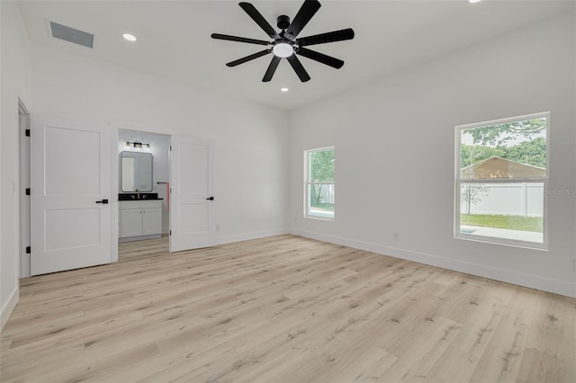 unfurnished bedroom featuring recessed lighting, connected bathroom, light wood-style flooring, baseboards, and visible vents