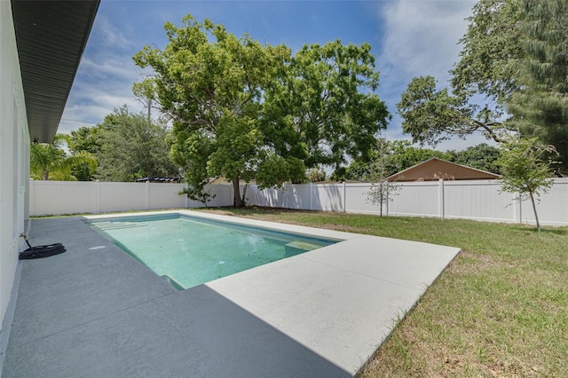 view of swimming pool featuring a fenced backyard, a yard, and a patio area
