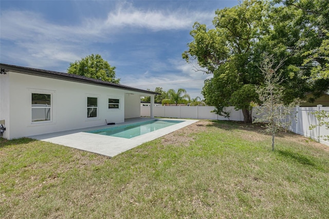 view of swimming pool with a yard, a patio, and a fenced backyard