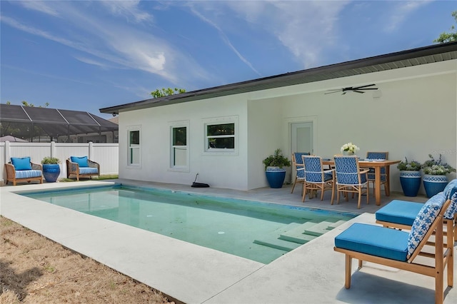 back of house with a patio, a fenced in pool, stucco siding, and fence