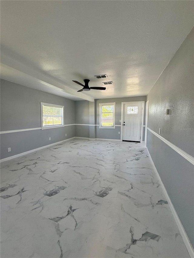 1318 W Broad St, Tampa, FL 33604 - empty room with a textured ceiling, visible vents, a wealth of natural light, and baseboards