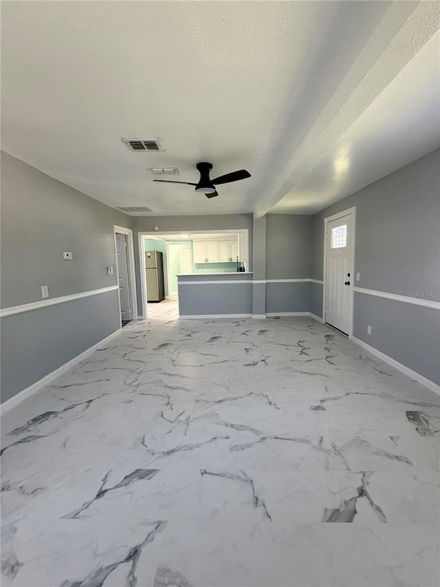 1318 W Broad St, Tampa, FL 33604 - unfurnished living room featuring baseboards, visible vents, a ceiling fan, and marble finish floor