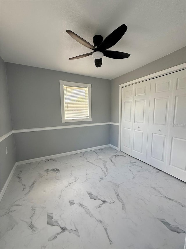 1318 W Broad St, Tampa, FL 33604 - unfurnished bedroom featuring a textured ceiling, ceiling fan, baseboards, a closet, and marble finish floor