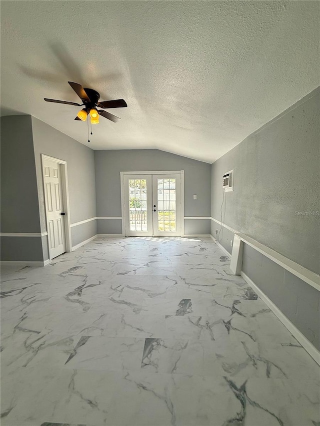 1318 W Broad St, Tampa, FL 33604 - spare room with a textured ceiling, ceiling fan, baseboards, vaulted ceiling, and french doors