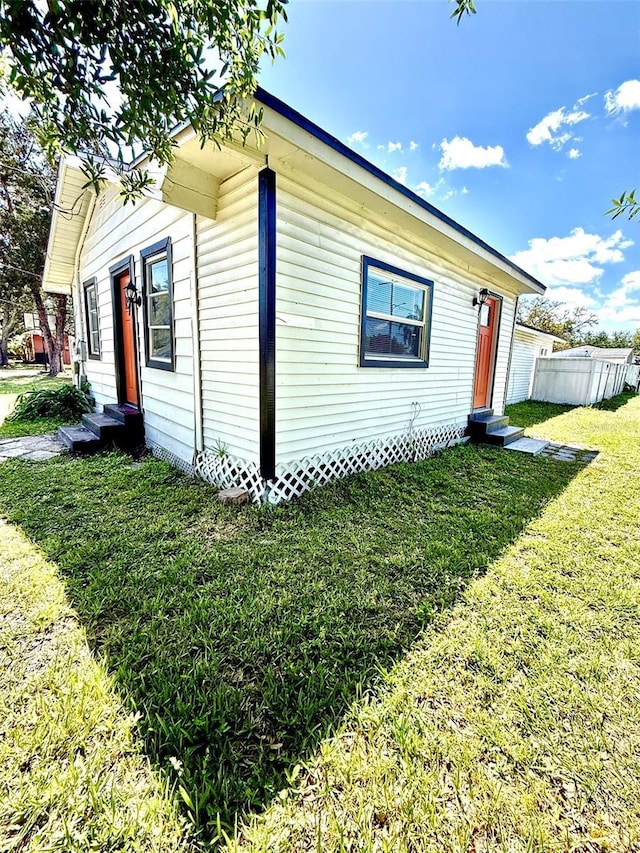 1318 W Broad St, Tampa, FL 33604 - view of home's exterior featuring fence, entry steps, and a lawn