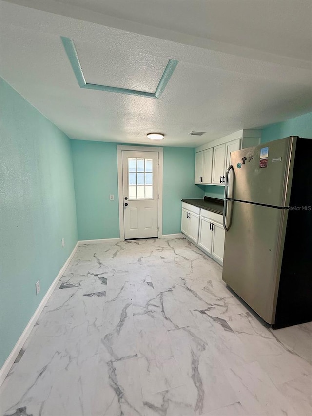 1318 W Broad St, Tampa, FL 33604 - kitchen featuring marble finish floor, white cabinets, freestanding refrigerator, and baseboards