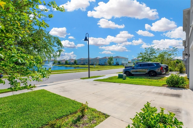 view of street with street lighting, a residential view, and a water view