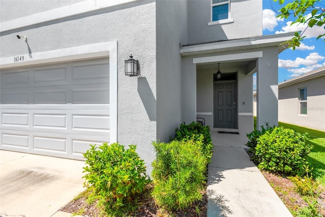 entrance to property featuring stucco siding
